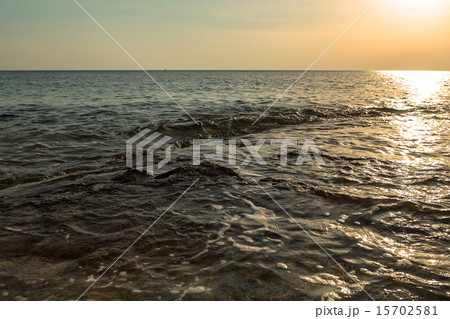 ocean wave at sunset 15702581