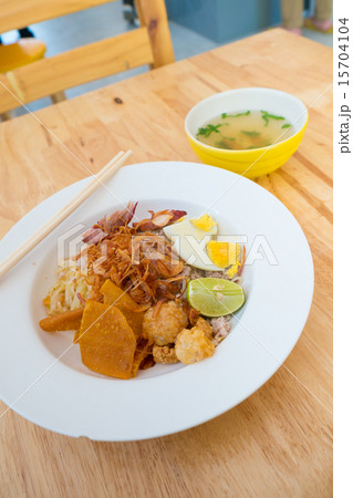 Asian dry noodle with garnish on the wooden background Asian dry noodle with garnish on the wooden background 15704104