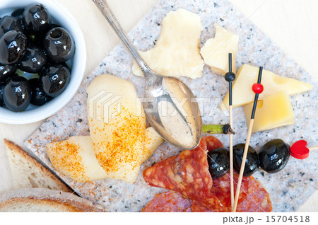 mix cold cut on a stone with fresh pears 15704518