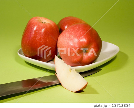 Red apples on green background 15712854