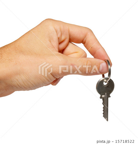 Silver key in a hand isolated on white. 15718522