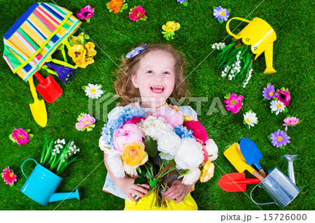 Kids on a lawn with garden tools 15726000