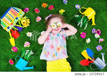 Kids on a lawn with garden tools 15726017
