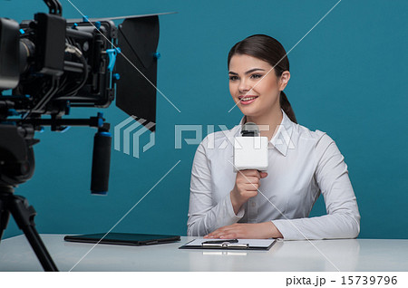 Beautiful girl tv newscaster with pretty smile reports 15739796