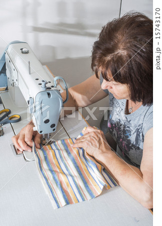 Women sew on sewing machine 15743170