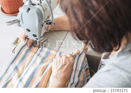 Women sew on sewing machine 15743171