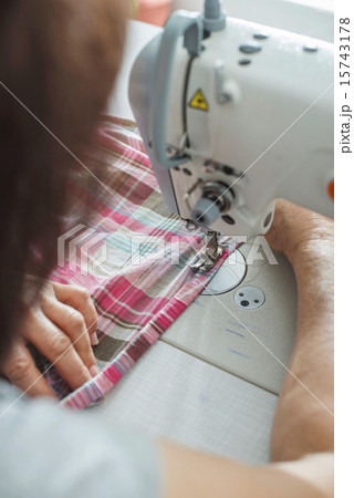 Women sew on sewing machine 15743178