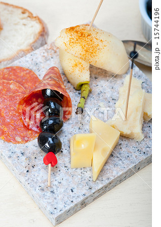 mix cold cut on a stone with fresh pears 15744196