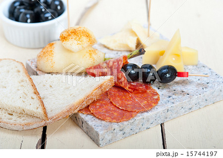 mix cold cut on a stone with fresh pears 15744197