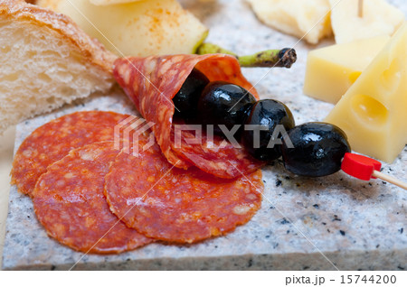 mix cold cut on a stone with fresh pears 15744200