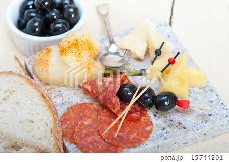 mix cold cut on a stone with fresh pears 15744201