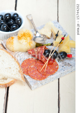 mix cold cut on a stone with fresh pears 15744202