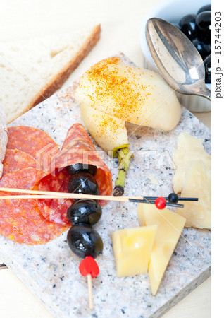 mix cold cut on a stone with fresh pears 15744203