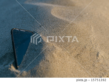Smartphone lost in the sand 15751392