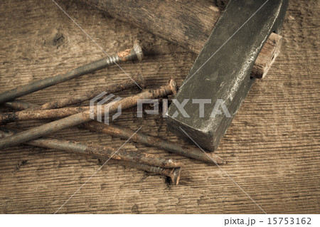 Vintage hammer with nails on wood background Vintage hammer with nails on wood background 15753162