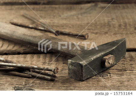 Vintage hammer with nails on wood background Vintage hammer with nails on wood background 15753164