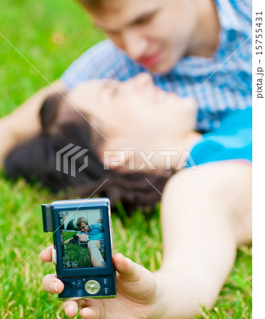 Happy teenage couple taking picture Happy teenage couple taking picture 15755431