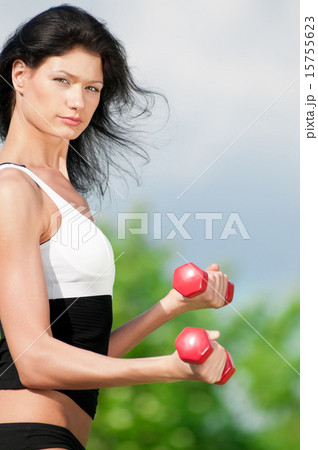 Woman doing exercise with dumbbell Woman doing exercise with dumbbell 15755623
