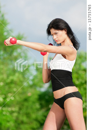 Woman doing exercise with dumbbell Woman doing exercise with dumbbell 15755765