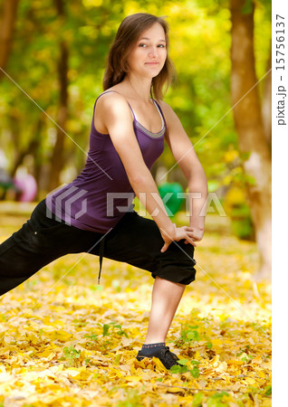 Woman doing yoga exercises in the autumn park Woman doing yoga exercises in the autumn park 15756137