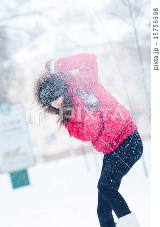 Happy young woman plays with a snow 15756398