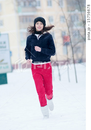 Young girl running on a cold winter day 15756678