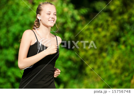 Young woman running in green park 15756748
