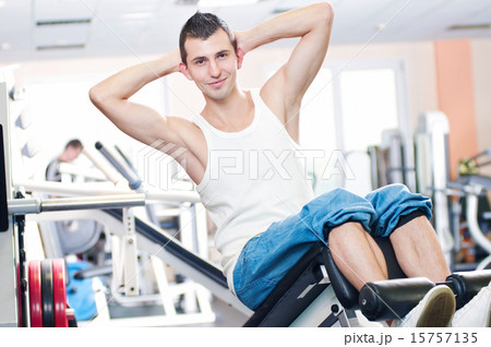 Young man doing exercises at gym Young man doing exercises at gym 15757135