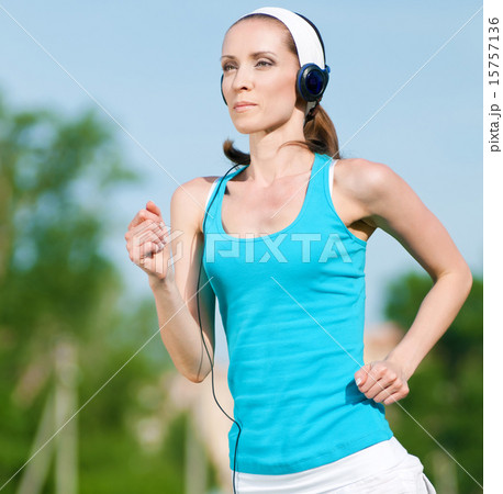 Beautiful woman running in green park Beautiful woman running in green park 15757136