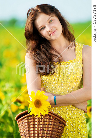 Beautiful woman in a sunflower field Beautiful woman in a sunflower field 15757138