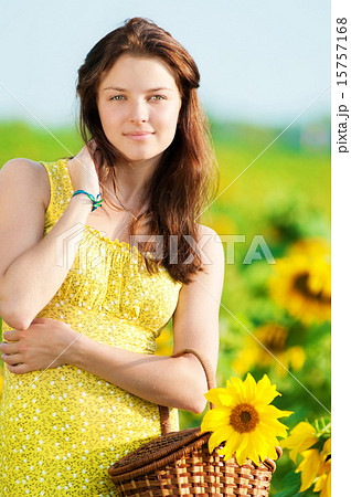 Beautiful woman in a sunflower field 15757168