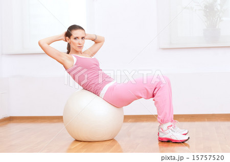 Woman doing stretching exercise on ball Woman doing stretching exercise on ball 15757520