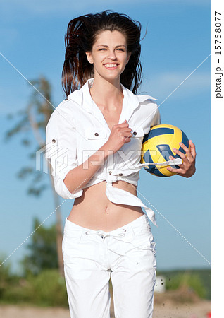 Woman playing volleyball on beach 15758077