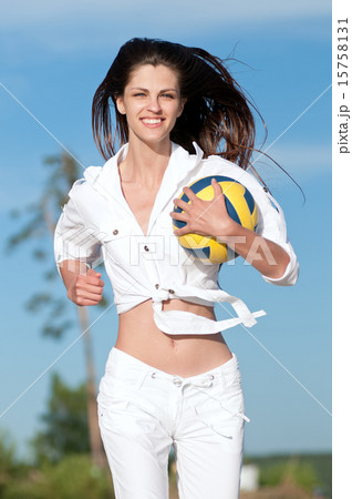 Woman playing volleyball on beach 15758131