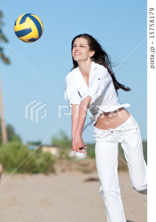 Woman playing volleyball on beach 15758179
