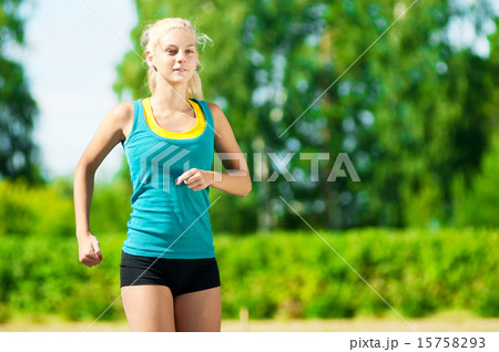 Young woman running in green park 15758293