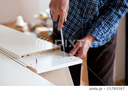 Man Assembling Flat Pack Furniture 15760367