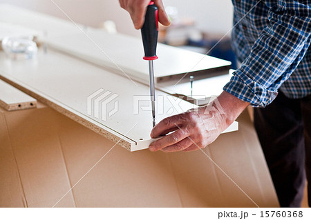 Man Assembling Flat Pack Furniture 15760368