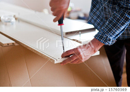 Man Assembling Flat Pack Furniture 15760369