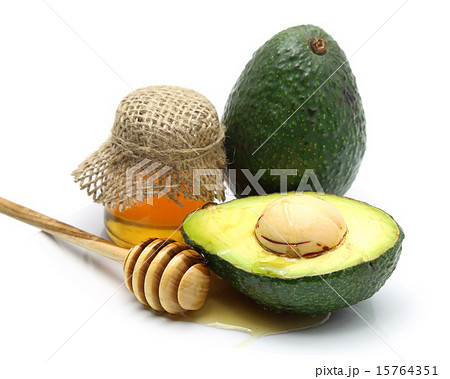 Avocado with honey dripping on white background 15764351