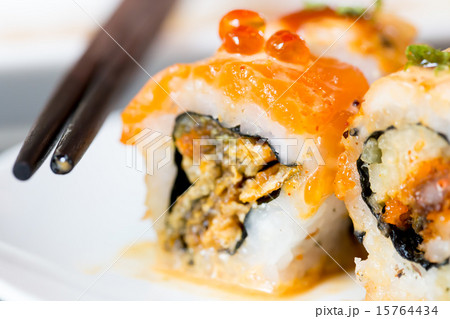 Sushi roll with black chopsticks Sushi roll with black chopsticks 15764434
