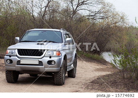 4x4 SUV on a road near a pond 4x4 SUV on a road near a pond 15774692