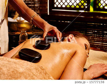 Woman having Ayurvedic stone massage. Woman having Ayurvedic stone massage. 15777156