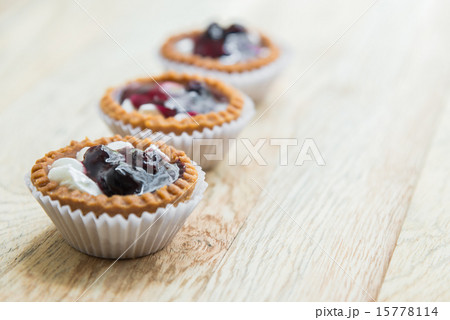 Three Blue berry tart on wooden floor 2 Three Blue berry tart on wooden floor 2 15778114