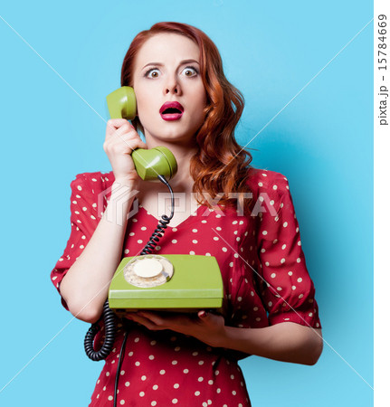 girl in red dress with green dial phone 15784669