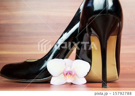 Female shoes with flower on wooden background 15792788