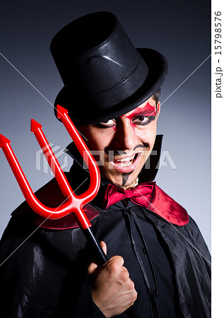 Man in devil costume in halloween concept 15798576