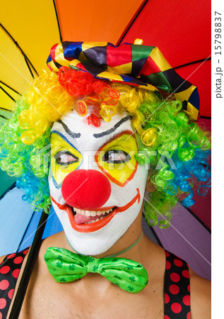 Clown with umbrella isolated on white 15798837
