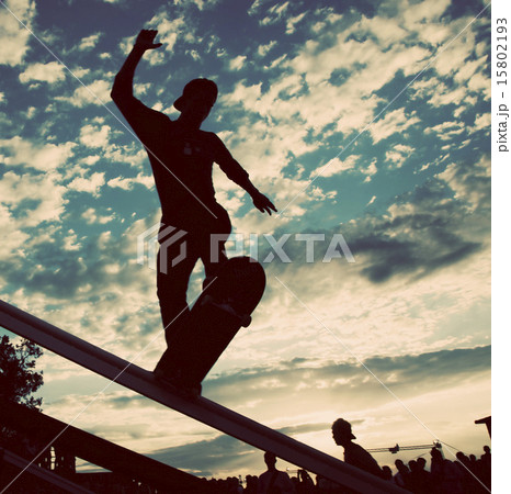 skateboarder silhouette doing a slide trick 15802193