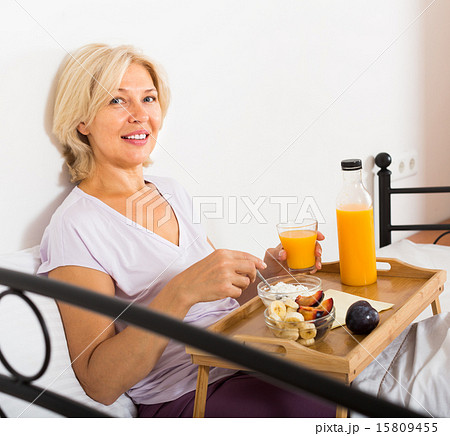mature woman enjoying healthy breakfast 15809455